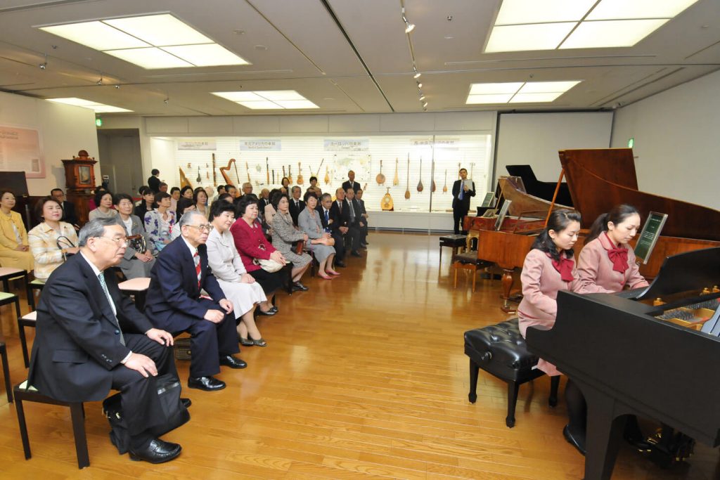 Guests at the opening ceremony enjoy the classical sounds of an antique fortepiano