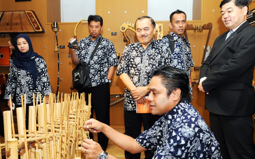 A member of institute plays an Indonesian Angklung on display in the Music Museum